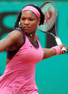 Serena Williams playing tennis in pink dress